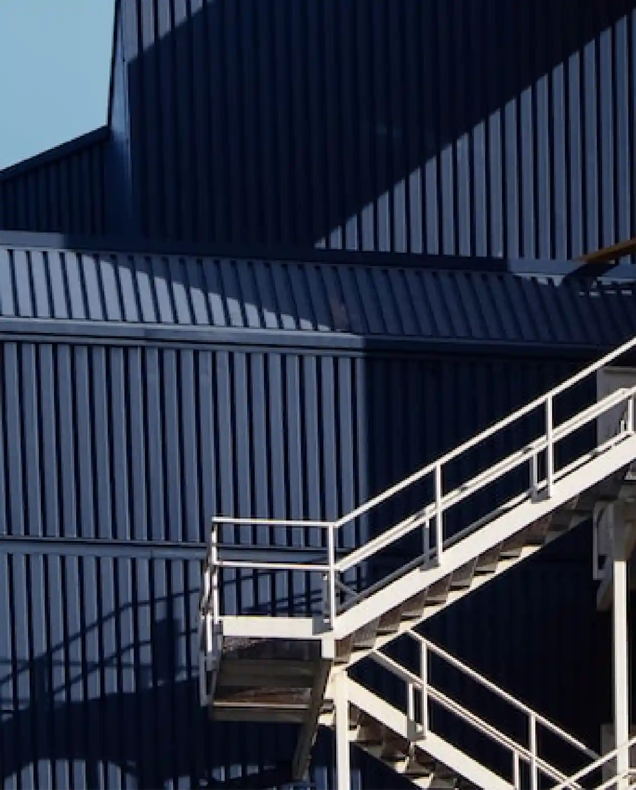 Exterior of an industrial building with black cladding