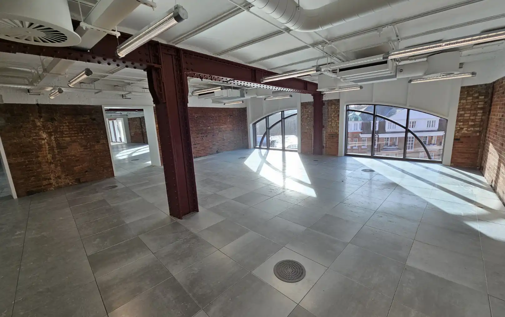 Interior commercial space with exposed brickwork and steel supports