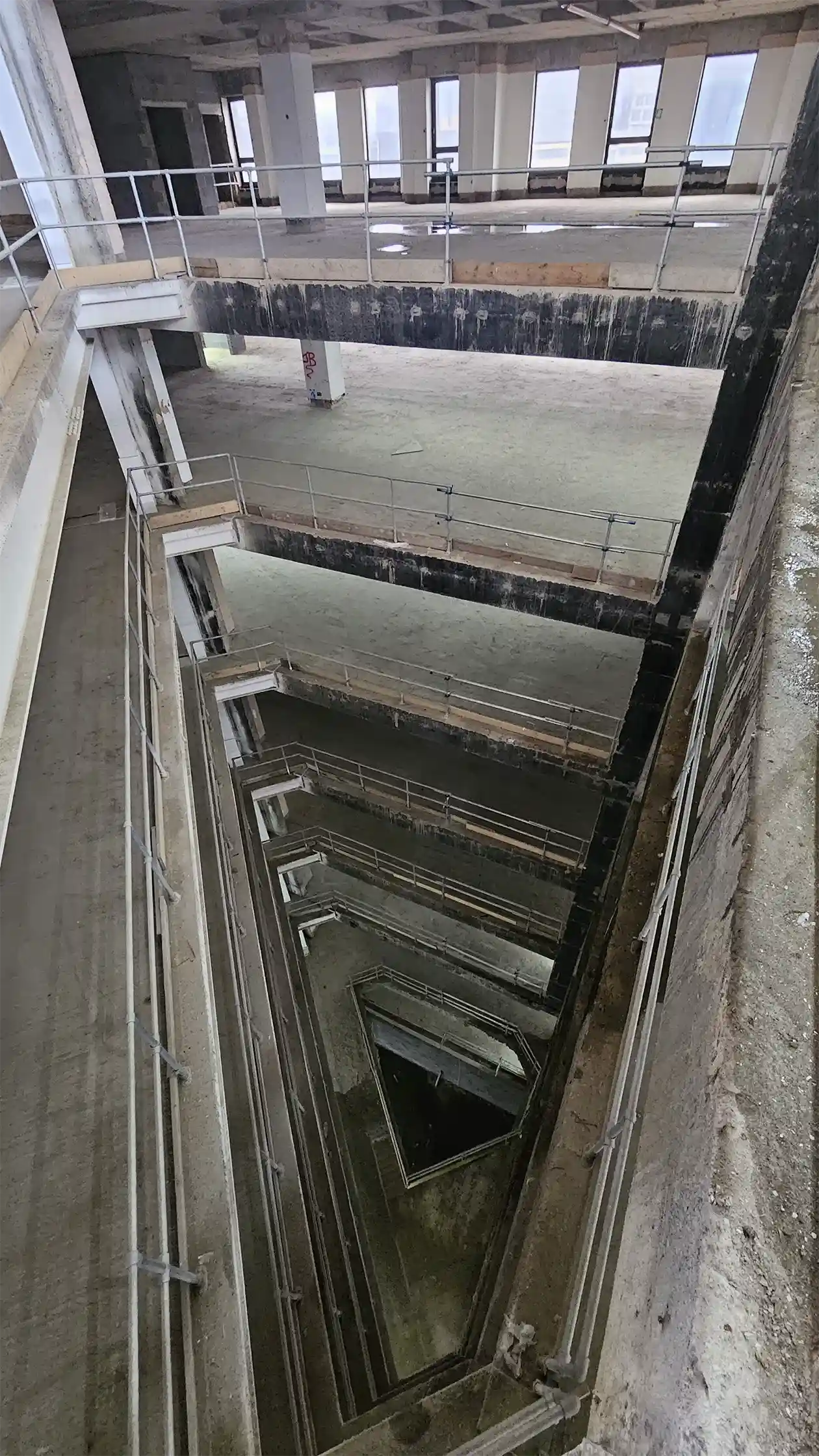 View looking down from the top of a concrete atrium